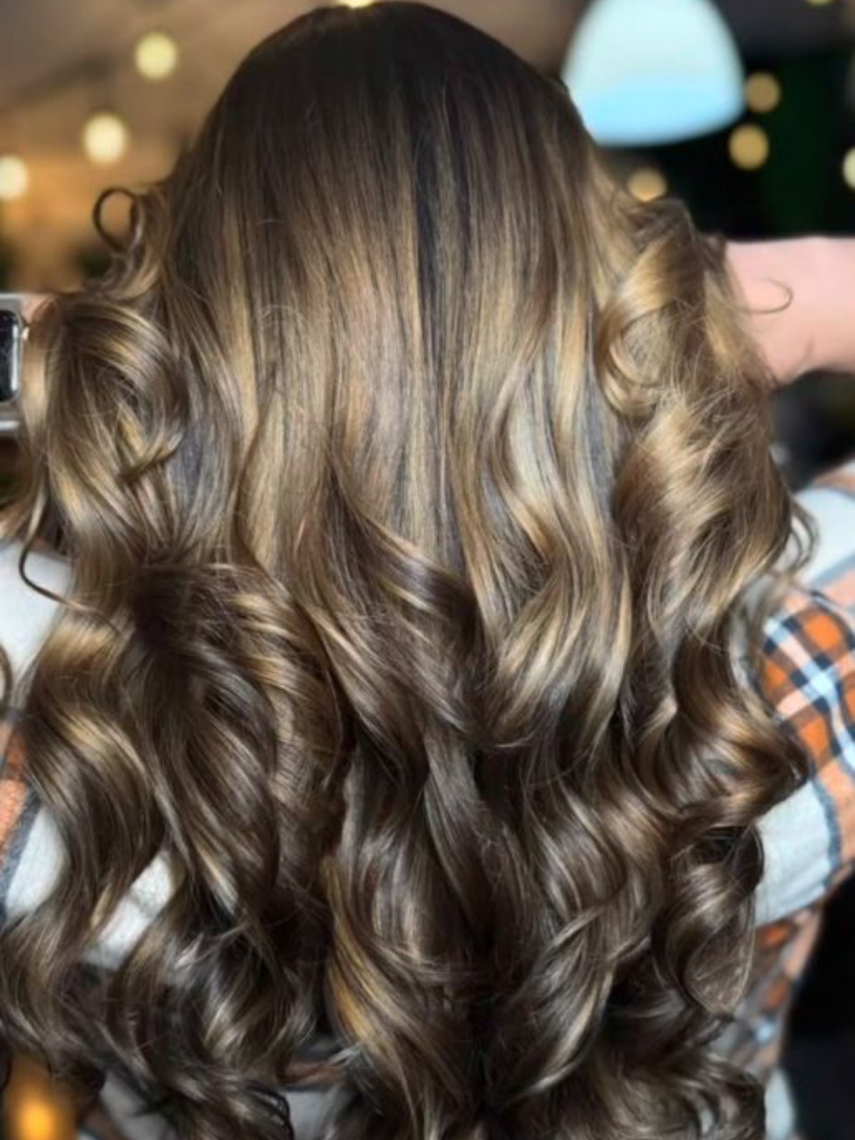 Dimensional brunette with caramel ribbons and a curled finish