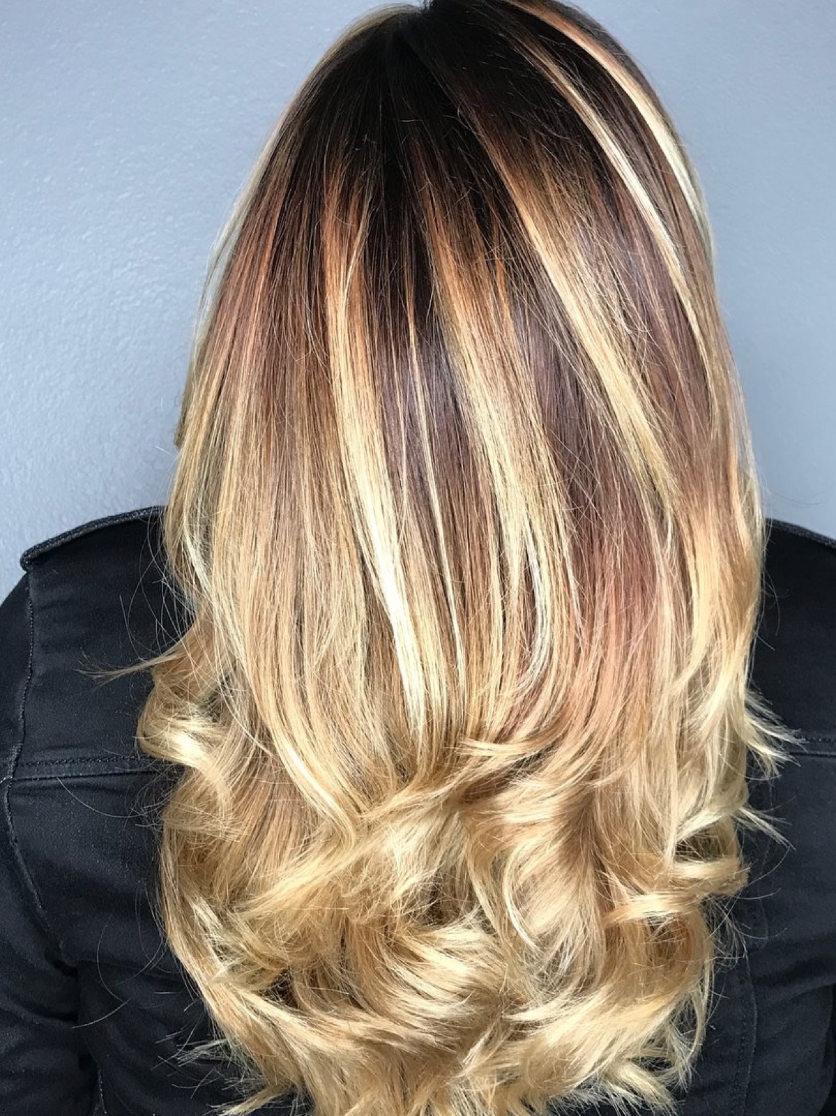 Warm caramel and blonde highlights over a dark base